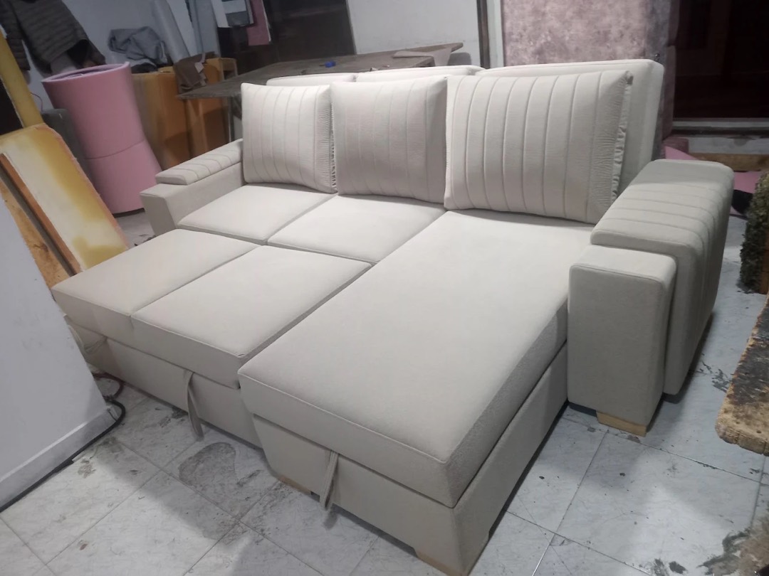 Sofá cama en L color beige con la cama extendida, fabricado en nuestro taller de Bogotá